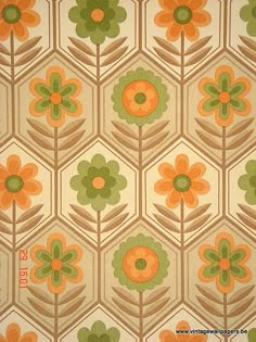 an orange and green flower pattern on fabric