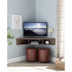 a flat screen tv sitting on top of a wooden shelf