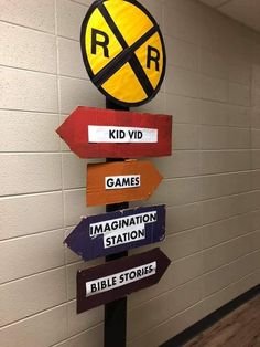 a sign that is on the side of a wall in a hallway with other signs attached to it