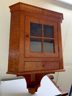 an old wooden cabinet sitting on top of a table