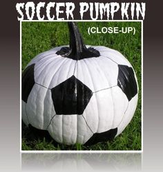 a soccer ball painted to look like a soccer ball on the grass with text reading soccer pumpkin close - up