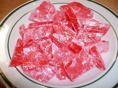 a white plate topped with red gummy bears