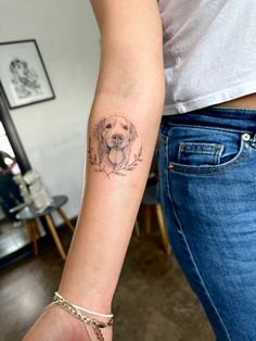 a woman with a dog tattoo on her arm