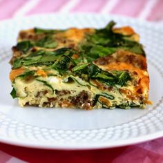 a white plate topped with a slice of vegetable lasagna