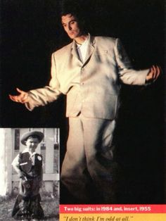 a man in a white suit and hat with his arms spread out to the side