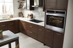 a kitchen with wooden cabinets and an oven in the center, along with white counter tops