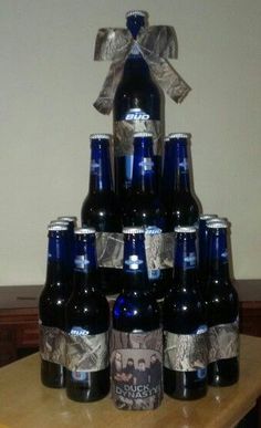 a large stack of beer bottles sitting on top of a wooden table