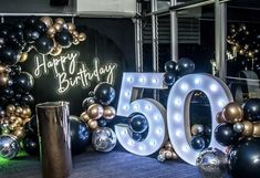 a 50th birthday party with balloons and lights