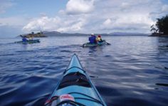 some people are paddling their kayaks in the water