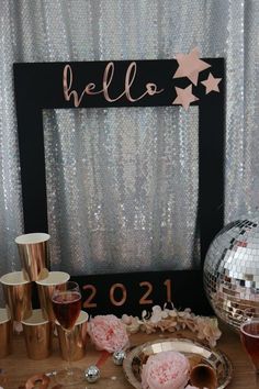 a table topped with lots of drinks and confetti next to a disco ball