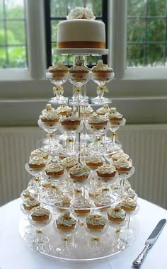 there is a cake and cupcakes on top of the table with silverware