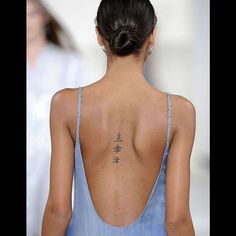 a woman with a tattoo on her back