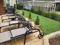 lounge chairs are lined up on the patio