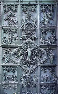 an intricately carved metal door with angels on it