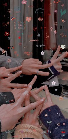 several hands reaching up to each other in front of a computer screen with hearts and stars on it