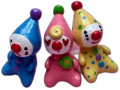 three toy clowns sitting next to each other