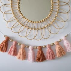 a mirror and some tassels on a wall