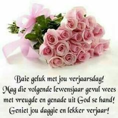 a bouquet of pink roses sitting on top of a white sheet with words written in german