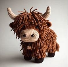 a crocheted stuffed animal with long hair on it's face and nose