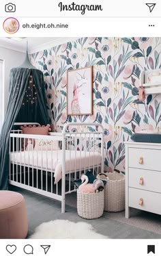 a baby's room with floral wallpaper and white crib