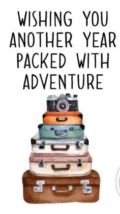 a stack of luggage with the words wishing you another year packed with adventure