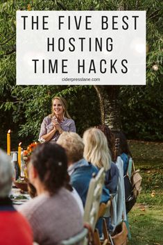 a group of people sitting around a table with candles on it and the words, the five best hosting time hacks