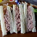 there are four sandwiches that have been cut in half and stacked on top of each other