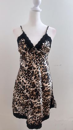 Introducing our leopard print slip dress, a stylish and trendy addition to your wardrobe. This dress features a leopard print pattern that adds a fashionable touch to the dress. The lace trim adds a delicate and feminine detail to the dress, making it perfect for a night out or a special occasion. The dress comes with adjustable straps, allowing for a customizable fit and ensuring comfort for the wearer. The slip dress design provides a comfortable and flattering fit, making it easy to move around in. Elegant Leopard Print V-neck Mini Dress, Lace Silk Dress, Print Slip Dress, Silk Clothing, Lacey Dress, Leopard Print Pattern, Dress Leopard, Silk Outfit, Fits Clothes