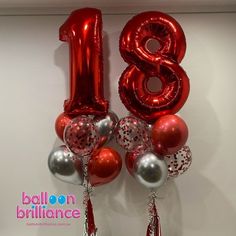 balloons and streamers are arranged in the shape of the number eighteen, with tassels