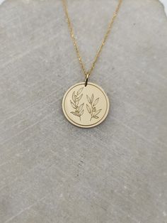 Olive Branch Necklace - Engraved Branch Leaf Charm - Gold Greek Leaf Charm - Gold Olive Tree Pendant ▪️ A beautiful and clean engraved Olive Branch pendant made out of 14K Solid Real Gold. Available only in yellow gold! Pendant Thickness: 0.50mm Jump Ring inner diameter: 4mm Dimensions: - 13mm / 0.52 inches - 15mm / 0.59 inches - 18mm / 0.70 inches - 20mm / 0.78 inches - 22mm / 0.86 inches - 24mm / 0.94 inches Necklace Length - You can choose your chain length from 35CM to 50CM. The pendant is a Nature-inspired Engraved Round Pendant Necklace, Minimalist Round Etched Necklace, Engraved Gold Nature-inspired Necklace, Nature-inspired Engraved Gold Necklace, Minimalist Laser Engraved Round Pendant Necklace, Stamping Jewelry, Branch Necklace, Engraved Pendant, Solid Gold Necklace