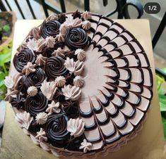 a chocolate cake sitting on top of a table covered in icing and flowers,