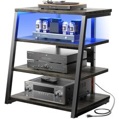 a shelf with some electronics on it and an amp in the bottom one that is blue