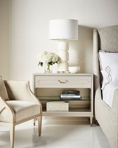 a bedroom scene with focus on the nightstand and chair, which has flowers on it