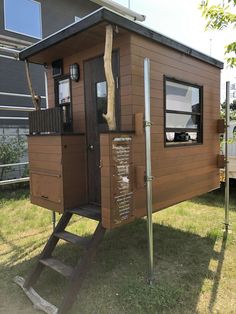 there is a small wooden house on the grass