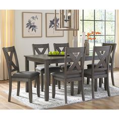 a dining room table with chairs and fruit on it