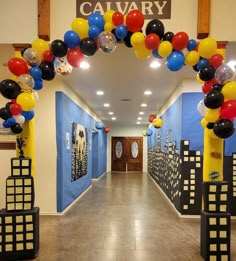 an entrance to a hallway decorated with balloons