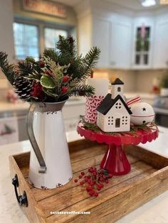 a tray that has some christmas decorations on it and a coffee pot in the middle