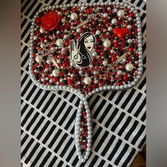 a black and white table cloth with a red beaded purse on top of it