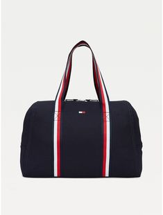 Tommy Hilfiger women's bag. Practicality and standout style come together in this spacious zip tote, showcasing our signature stripes at the handles for a branded finish.  Material: 100% Cotton. Sporty Canvas Gym Bag, Sporty Canvas Bag With Zipper Closure, Sporty Cotton Bags For Daily Use, Sporty Cotton Travel Bag, Sporty Rectangular Cotton Bag, Sporty Canvas Bags For On-the-go, Everyday Tommy Hilfiger Bag With Zipper Closure, Navy Sporty Bag With Zipper Closure, Sporty Navy Bag With Zipper Closure