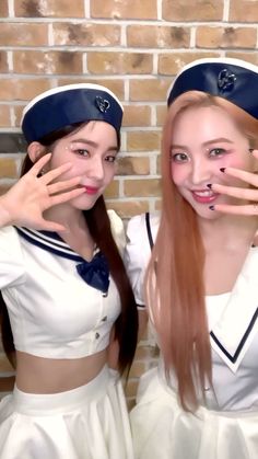 two young women dressed in sailor uniforms posing for a photo