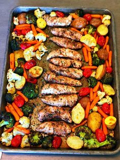 a pan filled with meat and vegetables on top of a wooden table