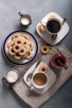 a table topped with cookies and cups of coffee