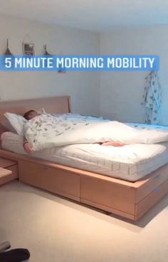 a man laying on top of a bed in a bedroom