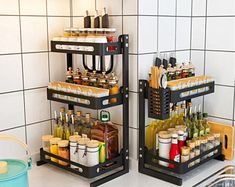 two black racks holding bottles and utensils in a white tiled kitchen countertop