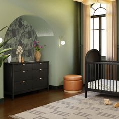 a baby's room with a crib, dresser and large potted plant