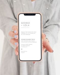 a person holding up a cell phone with the text george loua on it in front of them