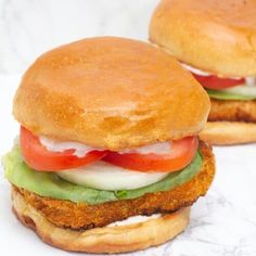 two chicken burgers with lettuce tomato and cheese