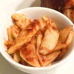 a white bowl filled with french fries on top of a table