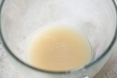 a glass filled with liquid sitting on top of a counter