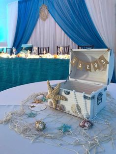 an open trunk sitting on top of a table next to a starfish and other decorations